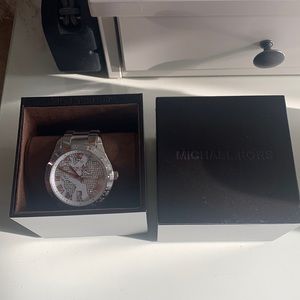 Silver Michael Kors watch with continents on face